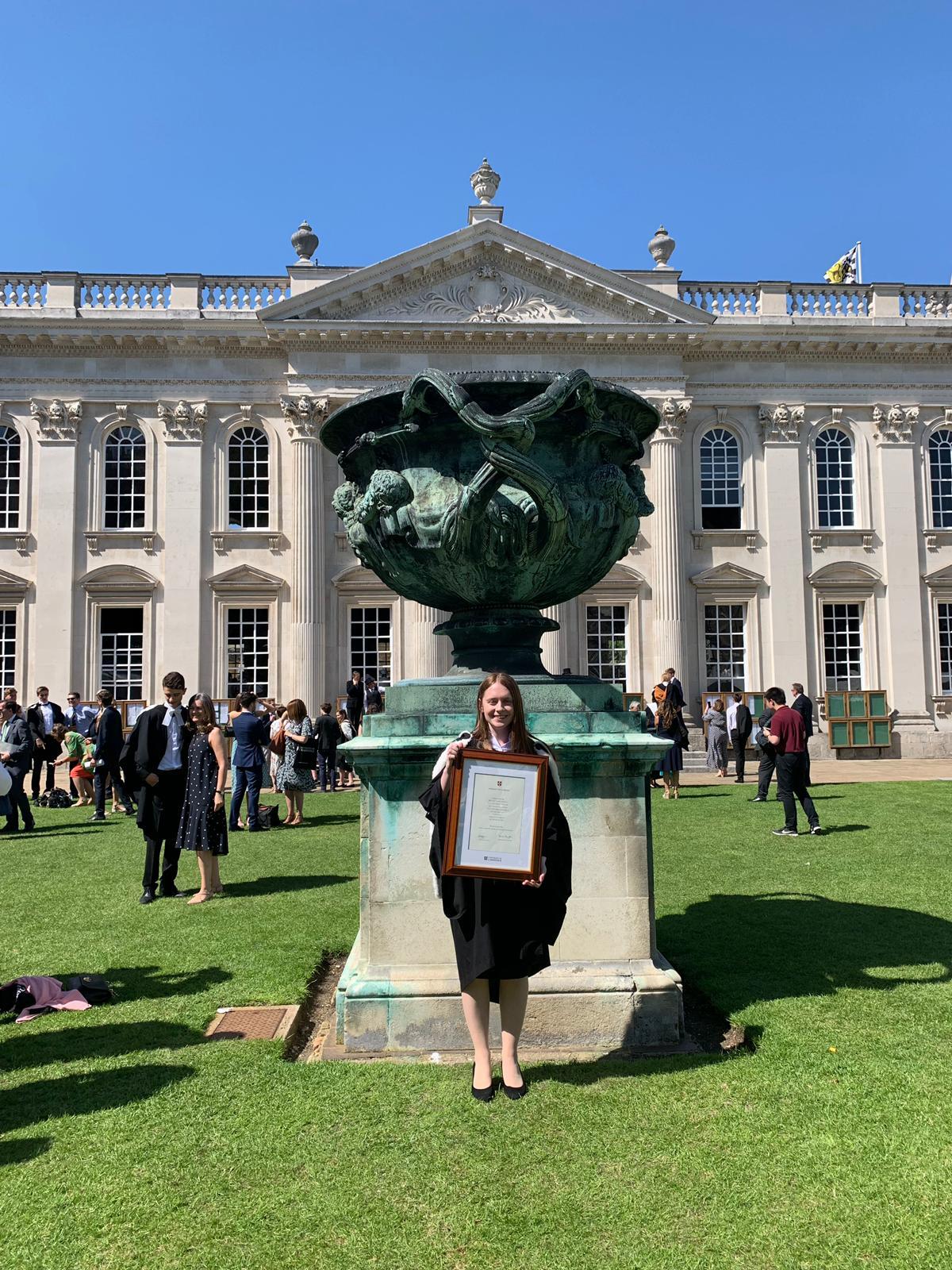 Bethany Downey posing with certificate