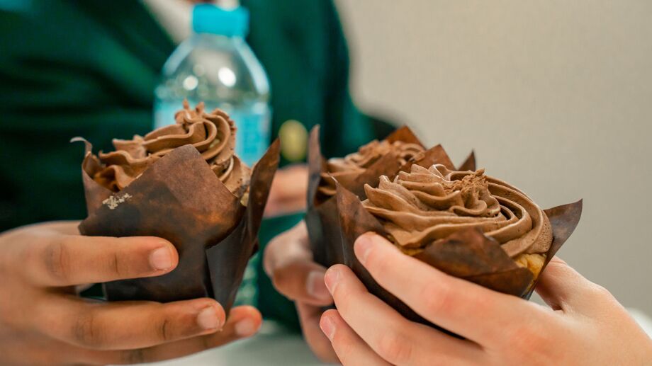 Students holding cupcakes from our caterer